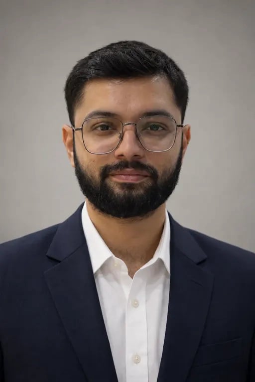 Vandan Sarvaiya, Chief Creative Officer of The Chronicle Factory, wearing glasses and a navy blazer